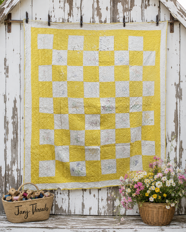 Yellow and white checkerboard quilt